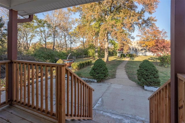 wooden deck featuring a yard and a patio