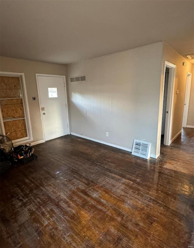 entryway featuring dark wood-style floors, visible vents, and baseboards