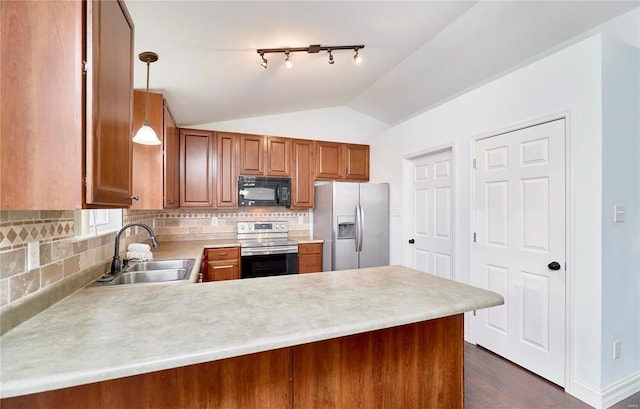 kitchen featuring light countertops, lofted ceiling, a peninsula, stainless steel appliances, and a sink