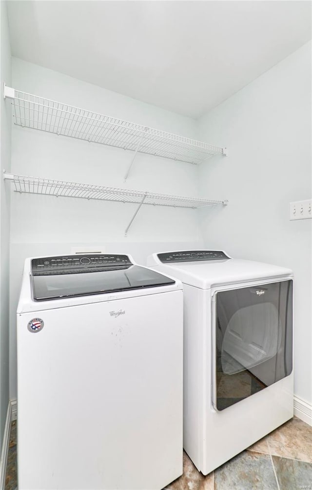 laundry room with laundry area, baseboards, and separate washer and dryer