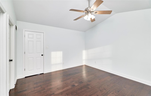 spare room featuring baseboards, a ceiling fan, lofted ceiling, and dark wood-style flooring