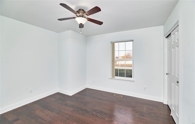 unfurnished bedroom with visible vents, baseboards, dark wood finished floors, a closet, and a ceiling fan