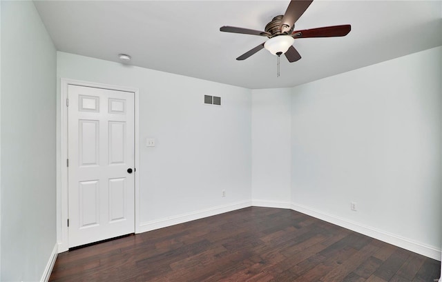 spare room featuring visible vents, baseboards, dark wood-style floors, and ceiling fan