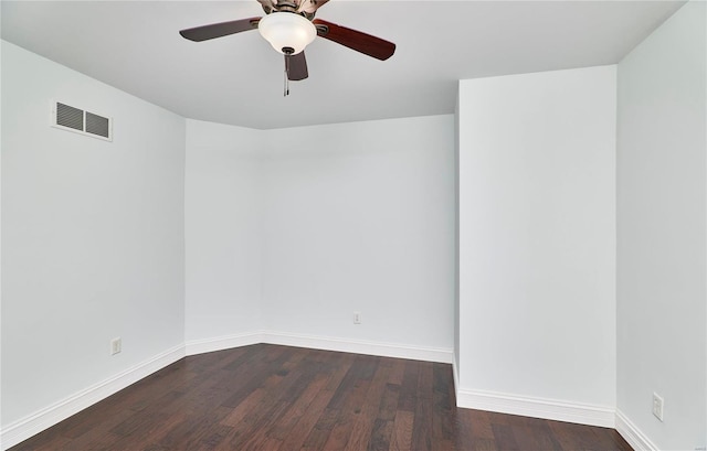 spare room with ceiling fan, visible vents, baseboards, and wood finished floors