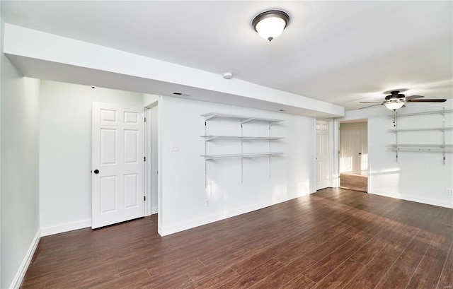 unfurnished living room featuring visible vents, baseboards, wood finished floors, and a ceiling fan