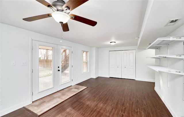 interior space featuring visible vents, french doors, baseboards, ceiling fan, and dark wood-style flooring