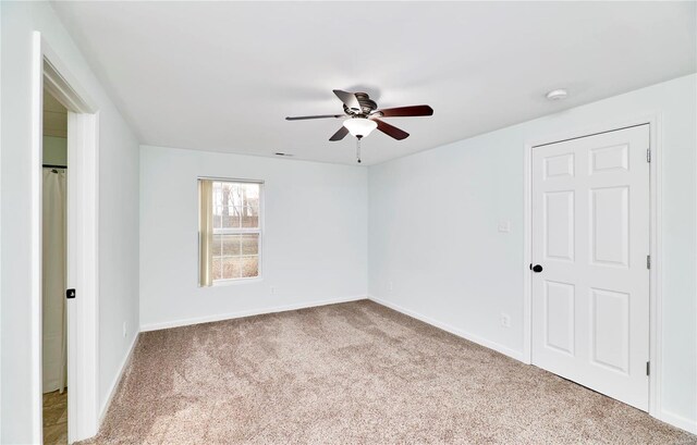 unfurnished bedroom with ceiling fan, baseboards, and carpet floors