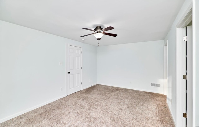 unfurnished room featuring visible vents, ceiling fan, baseboards, and carpet