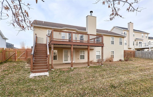 rear view of property with stairs, a patio, a deck, and a fenced backyard