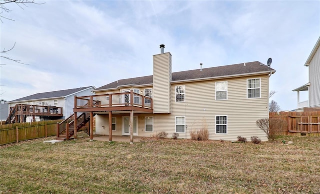 back of property featuring a patio area, a chimney, a fenced backyard, and a wooden deck