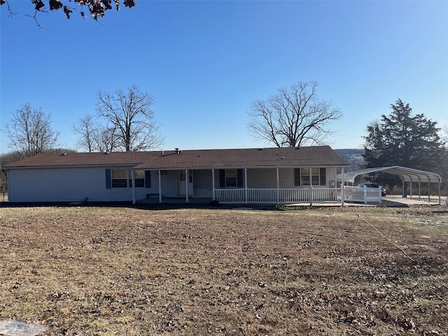 view of front of house with a detached carport and covered porch