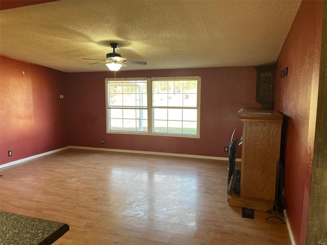 unfurnished room featuring baseboards, ceiling fan, and light wood finished floors