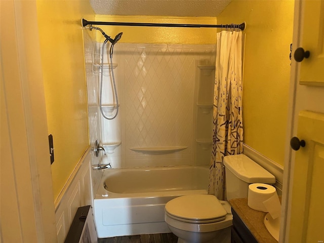 full bath with a textured ceiling, toilet, and shower / bath combo with shower curtain