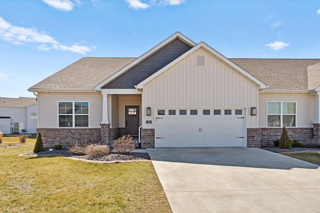 craftsman-style home featuring board and batten siding, concrete driveway, a front yard, roof with shingles, and a garage