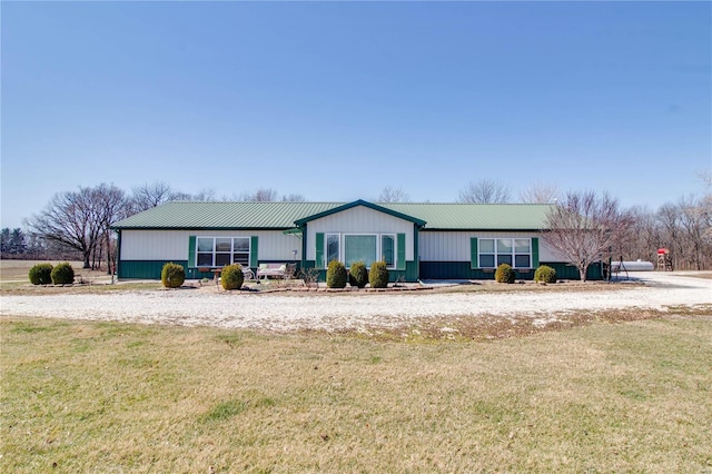 view of front of house with a front yard and metal roof