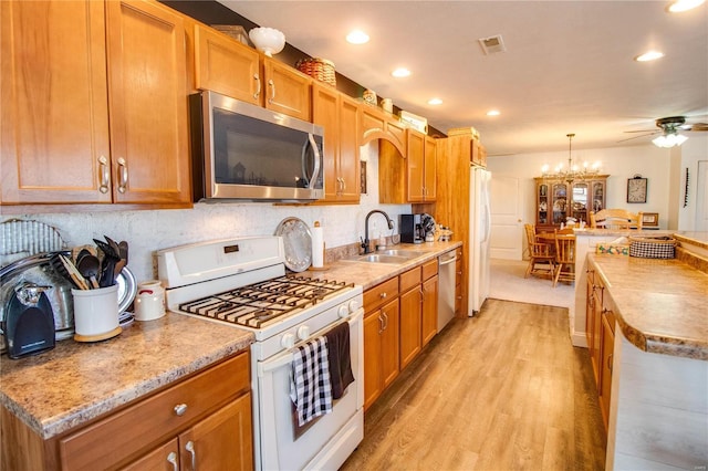 kitchen with visible vents, light countertops, light wood-type flooring, appliances with stainless steel finishes, and a sink