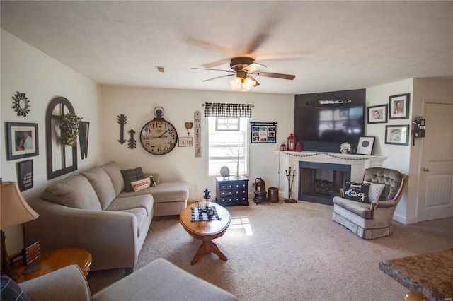 living area featuring visible vents, carpet floors, a ceiling fan, and a fireplace