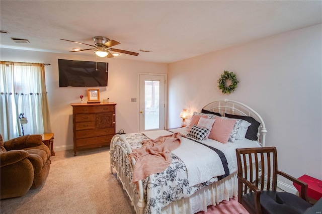 carpeted bedroom with visible vents, a ceiling fan, and baseboards