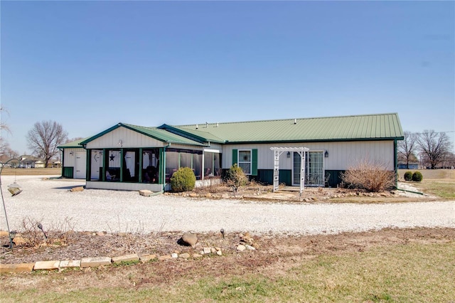 view of front of property with a pergola, a sunroom, and metal roof