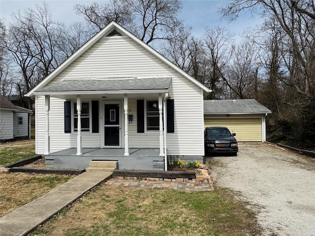 bungalow-style home featuring a porch and dirt driveway