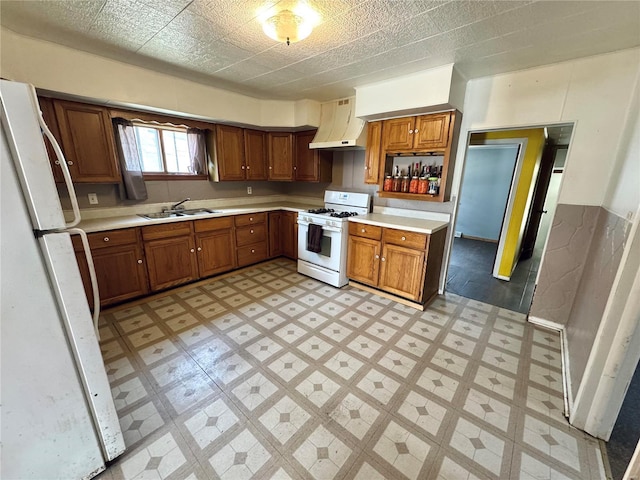 kitchen with brown cabinets, a sink, white appliances, extractor fan, and light floors