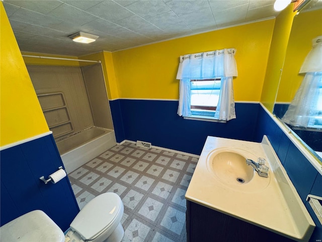 full bath with tile patterned floors, toilet, wainscoting, and vanity