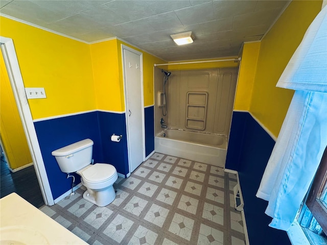 full bath featuring tile patterned floors, toilet, baseboards, and shower / washtub combination