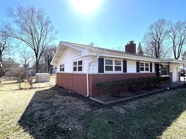 view of side of property featuring brick siding, fence, a lawn, a chimney, and an attached garage