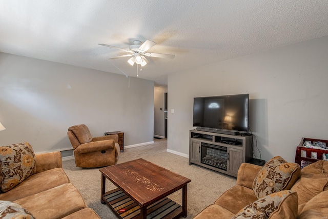 living room featuring light carpet, baseboards, a textured ceiling, and ceiling fan