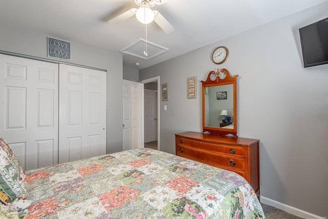 carpeted bedroom with a closet, attic access, baseboards, and a ceiling fan