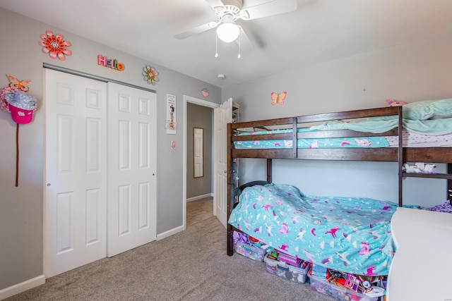 bedroom featuring a closet, baseboards, carpet, and a ceiling fan