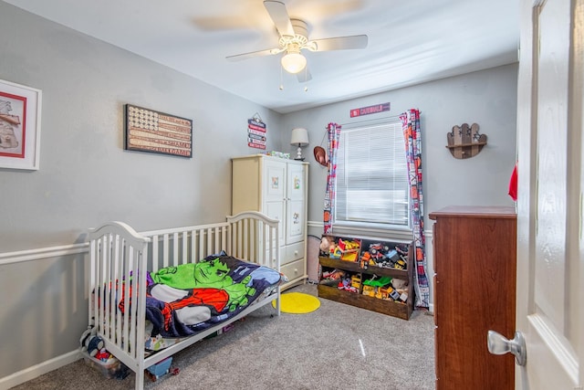 carpeted bedroom featuring baseboards and a ceiling fan