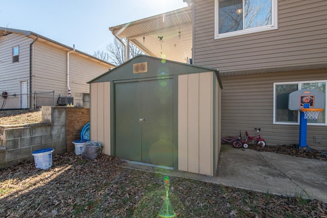 view of shed featuring fence