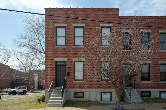 multi unit property featuring entry steps and brick siding