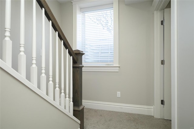 stairs featuring baseboards and carpet floors