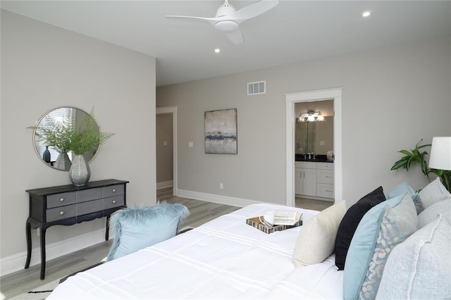 bedroom with visible vents, light wood-style flooring, recessed lighting, connected bathroom, and baseboards