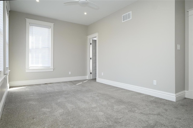 carpeted spare room with visible vents, recessed lighting, baseboards, and ceiling fan