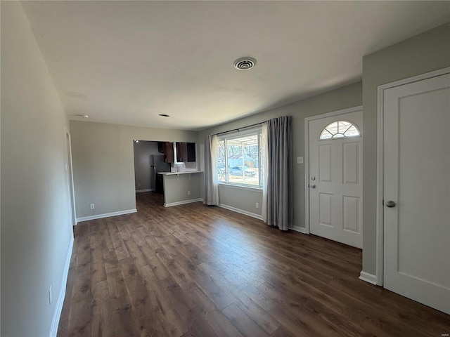 entrance foyer with dark wood-type flooring, baseboards, and visible vents