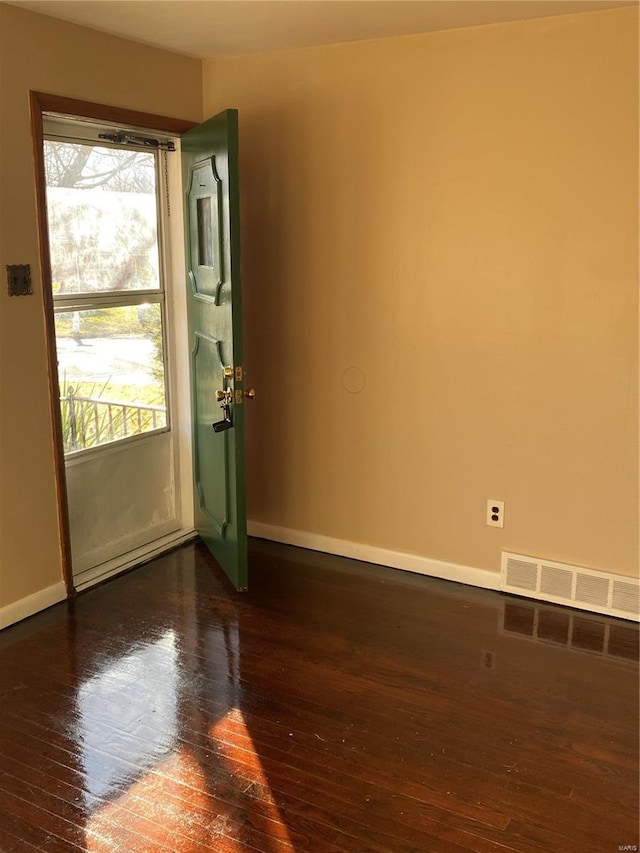 entryway featuring visible vents, baseboards, and hardwood / wood-style floors