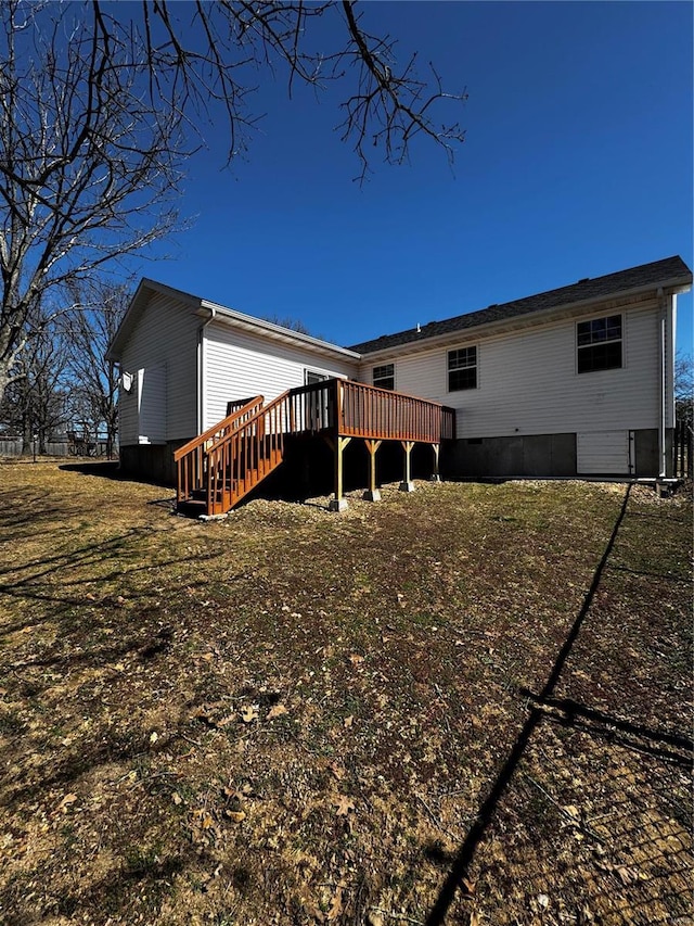 back of property featuring crawl space and a wooden deck