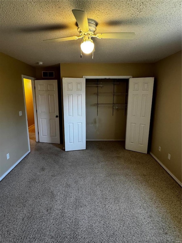 unfurnished bedroom with carpet, visible vents, a closet, and baseboards