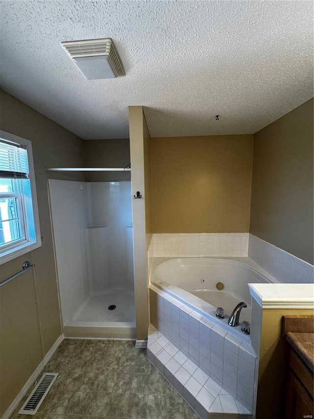 full bath featuring visible vents, a textured ceiling, a stall shower, and a whirlpool tub