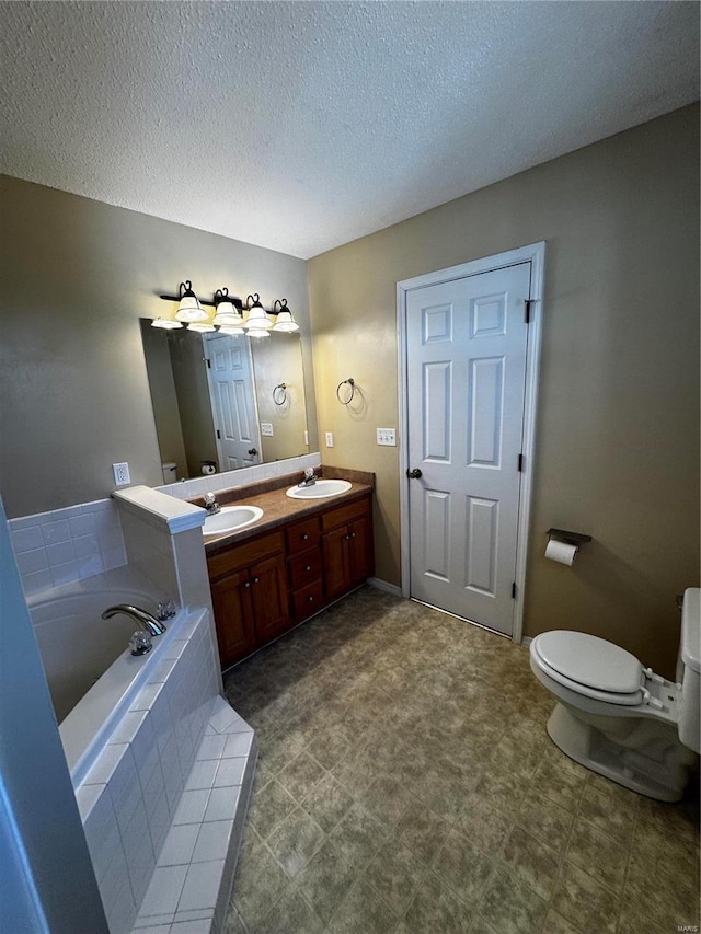 full bathroom with toilet, double vanity, a bath, and a sink