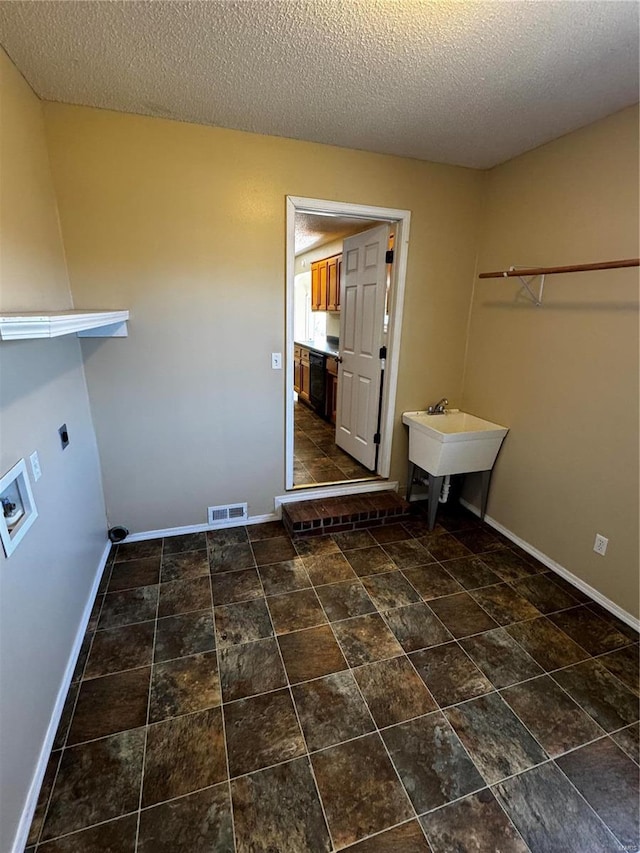 washroom featuring visible vents, washer hookup, laundry area, electric dryer hookup, and a sink