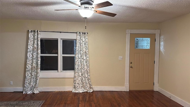 foyer entrance with a textured ceiling, a ceiling fan, baseboards, and wood finished floors