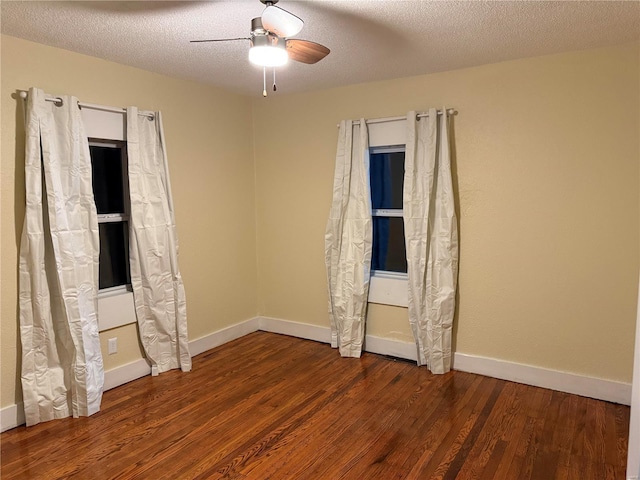 unfurnished bedroom featuring baseboards, a textured ceiling, and wood finished floors