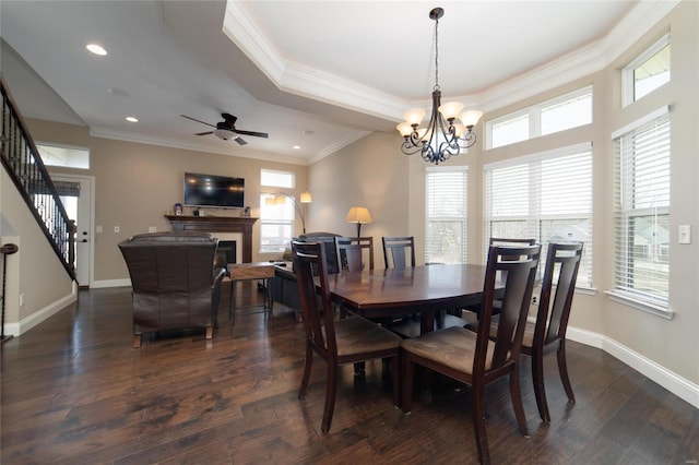 dining room featuring baseboards, dark wood-style flooring, a fireplace, and ornamental molding