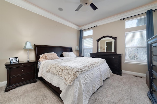 bedroom with visible vents, crown molding, baseboards, light carpet, and a ceiling fan