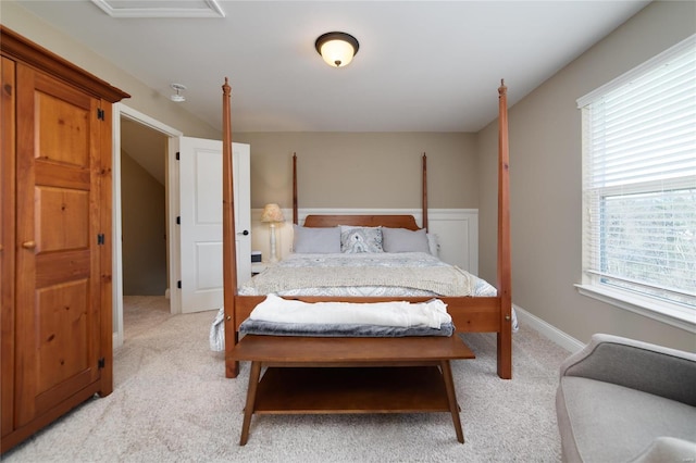 bedroom with light carpet and baseboards