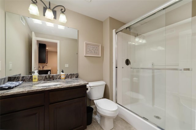 full bathroom with tile patterned flooring, a stall shower, toilet, and vanity